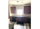 Stylish kitchen with granite countertops, tile backsplash, and dark wood cabinetry at 4346 Traipse Path, Ellenwood, GA 30294