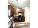 Functional kitchen equipped with granite countertops, black appliances, and plenty of cabinet storage at 4346 Traipse Path, Ellenwood, GA 30294