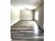 Bright living room with ample natural light and modern gray wood-look flooring at 4346 Traipse Path, Ellenwood, GA 30294