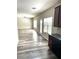 Open living room featuring wood-look floors that connect to the kitchen area at 4346 Traipse Path, Ellenwood, GA 30294