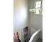 Stairwell with a modern chandelier and neutral paint, leading to the upper floor at 4346 Traipse Path, Ellenwood, GA 30294