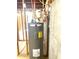 Close-up of a Rheem water heater surrounded by unfinished basement framing and visible pipes and wiring at 4346 Traipse Path, Ellenwood, GA 30294