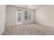 Spacious bedroom with natural light from a glass door leading to a balcony and window at 6023 Brookside Oak Cir, Norcross, GA 30093