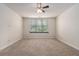 Neutral carpeted bedroom features great natural light, ceiling fan and ample square footage at 6023 Brookside Oak Cir, Norcross, GA 30093