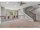 Open-concept hallway features carpet floors, a ceiling fan, and staircase with modern railings at 6023 Brookside Oak Cir, Norcross, GA 30093