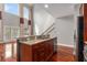 Kitchen island with granite countertop and sink overlooking the living area and outdoor access at 6023 Brookside Oak Cir, Norcross, GA 30093