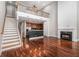 View of open concept living area and kitchen with hardwood floors and staircase at 6023 Brookside Oak Cir, Norcross, GA 30093