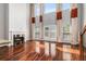 Spacious living room with fireplace, hardwood floors, and floor-to-ceiling windows at 6023 Brookside Oak Cir, Norcross, GA 30093