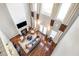 High-angle view of a well-lit living room featuring a cozy fireplace and hardwood floors at 6023 Brookside Oak Cir, Norcross, GA 30093