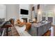 Open-concept living room with a fireplace, TV, and comfortable seating at 6023 Brookside Oak Cir, Norcross, GA 30093