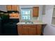 Compact kitchen features an updated sink, cabinetry and modern gas range and refrigerator at 103 Rigby Ne St, Marietta, GA 30060