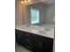 Modern bathroom featuring a double vanity with white countertops and sleek, dark cabinetry at 1536 Drew Nw Dr, Atlanta, GA 30318