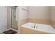 Bright bathroom featuring a shower, and a soaking tub with tile surround at 1536 Drew Nw Dr, Atlanta, GA 30318