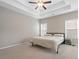 Bedroom with a tray ceiling, fan, and carpet at 1536 Drew Nw Dr, Atlanta, GA 30318