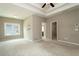 Large bedroom featuring a tray ceiling, ceiling fan, carpet, and window at 1536 Drew Nw Dr, Atlanta, GA 30318
