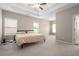 Large bedroom with a tray ceiling, ceiling fan, and carpet at 1536 Drew Nw Dr, Atlanta, GA 30318