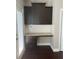 Convenient butler's pantry off the kitchen with granite countertop, dark cabinets, and white subway tile backsplash at 1536 Drew Nw Dr, Atlanta, GA 30318