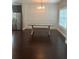 Open dining room with hardwood floors and decorative wall trim next to stainless steel refrigerator at 1536 Drew Nw Dr, Atlanta, GA 30318