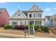 Charming two-story home with manicured lawn and inviting front porch with easy access to nearby road at 1536 Drew Nw Dr, Atlanta, GA 30318