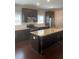 Gourmet kitchen with granite countertops, stainless steel appliances, and center island with dark wood cabinets at 1536 Drew Nw Dr, Atlanta, GA 30318