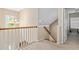 Light-filled upstairs hallway with wooden banister overlooking the stairs and bedrooms at 1536 Drew Nw Dr, Atlanta, GA 30318