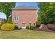 Well-maintained brick backyard with a garden, lush landscaping, and privacy at 605 Tatum Ct, Alpharetta, GA 30022