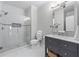 Spa-like bathroom featuring a glass enclosed shower, vanity with sink, and white tile at 605 Tatum Ct, Alpharetta, GA 30022