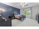 Charming bedroom with dark accent wall, ceiling fan, and bright window at 605 Tatum Ct, Alpharetta, GA 30022