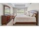 Bright bedroom with a large window, neutral colors, a dresser and a comfortable queen size bed at 605 Tatum Ct, Alpharetta, GA 30022