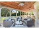 Cozy covered porch with ceiling fans, wood ceiling, comfortable wicker furniture and views of the yard at 605 Tatum Ct, Alpharetta, GA 30022