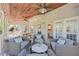 Relaxing covered porch with ceiling fans, wood ceiling, wicker furniture and access to interior at 605 Tatum Ct, Alpharetta, GA 30022