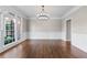Formal dining room showcases hardwood flooring, wainscoting, and a stylish chandelier at 605 Tatum Ct, Alpharetta, GA 30022