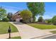 Beautiful brick home with well-manicured lawn, three car garage and long driveway at 605 Tatum Ct, Alpharetta, GA 30022