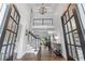 Grand foyer with soaring ceilings, hardwood floors, and elegant staircase at 605 Tatum Ct, Alpharetta, GA 30022