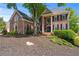 Elegant brick residence showcases a beautifully landscaped front yard and a welcoming facade at 605 Tatum Ct, Alpharetta, GA 30022