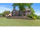 Stately brick home boasts a lush landscaped front yard and classic architectural details at 605 Tatum Ct, Alpharetta, GA 30022