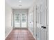 Hallway featuring tiled floors, double doors, and ample natural light at 605 Tatum Ct, Alpharetta, GA 30022