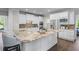 Kitchen with large island with seating, stainless steel appliances, and white cabinets at 605 Tatum Ct, Alpharetta, GA 30022
