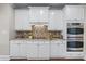 Kitchen with white cabinets, a tiled backsplash, and stainless steel appliances at 605 Tatum Ct, Alpharetta, GA 30022