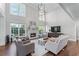 Bright living room with tall ceilings, fireplace, many windows and hardwood floors at 605 Tatum Ct, Alpharetta, GA 30022