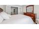Calm main bedroom with a large bed, french doors, and a dresser with a mirror at 605 Tatum Ct, Alpharetta, GA 30022
