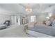 Spacious main bedroom with a sitting area, ensuite bathroom, walk in closet, and natural light at 605 Tatum Ct, Alpharetta, GA 30022