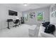 Well-lit home office with modern desk setup, comfortable seating, and large windows at 605 Tatum Ct, Alpharetta, GA 30022