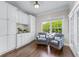 Bright sitting area with hardwood floors, white cabinets, granite counters and views of exterior greenery at 605 Tatum Ct, Alpharetta, GA 30022