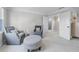 Comfortable sitting room with neutral decor, two arm chairs, ottoman, and carpet at 605 Tatum Ct, Alpharetta, GA 30022
