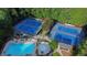 Aerial view of community tennis courts and pool area surrounded by mature trees at 605 Tatum Ct, Alpharetta, GA 30022