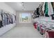 Spacious walk-in closet with custom shelving and a window offering natural light at 605 Tatum Ct, Alpharetta, GA 30022