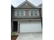 Two-story home featuring gray siding, a white garage door, and complementary light gray window shutters at 1120 Edinberg Dr # 61, Villa Rica, GA 30180