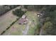 Aerial view showing the home, outbuildings and surrounding wooded acreage at 1277 Bethany Rd, Covington, GA 30016