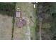 Aerial view showcasing the property layout, including the house, outbuildings, and surrounding greenery at 1277 Bethany Rd, Covington, GA 30016